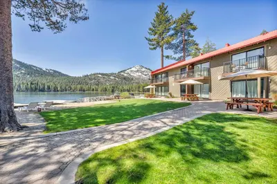 a resort building with a picnic table and a lake at Spacious 1BR Condo w/ Lake View #136 at Donner Lake Village in Truckee