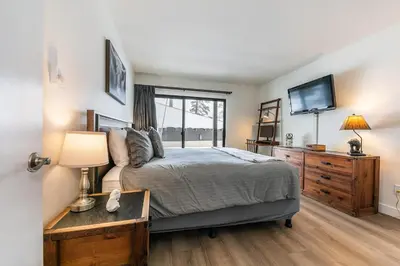a bedroom with a bed with a television and a dresser at Inviting King Deluxe 1 BR Condo W/Lake view #141 at Donner Lake Village in Truckee