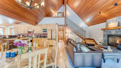 a living room with a couch and a fireplace at Minutes to Ski Resorts 5min Walk to Lake Sunnyside Ward Creek by AvantStay in Tahoe City