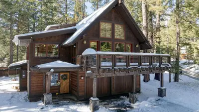 a cabin in the woods with snow on the roof at Minutes to Ski Resorts 5min Walk to Lake Sunnyside Ward Creek by AvantStay in Tahoe City