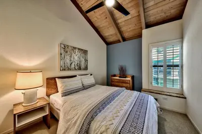 a bedroom with a bed and a window at Lakeland Village 620 - Beachfront Bliss in South Lake Tahoe