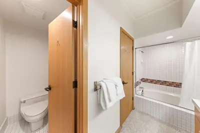 a bathroom with a toilet and a tub and a sink at Palisades Tahoe Lodge Rentals One Bedroom #120 in Olympic Valley