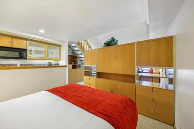 a bedroom with a bed and wooden cabinets at Palisades Tahoe Lodge Rentals Studio Loft #307 in Olympic Valley