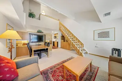 a living room with a couch and a table at Palisades Tahoe Lodge Rentals Studio Loft #307 in Olympic Valley