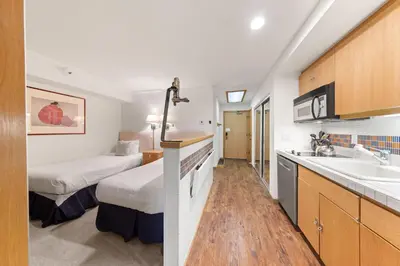 a hotel room with two beds and a sink at Palisades Tahoe Lodge Rentals Studio Loft #308 in Olympic Valley