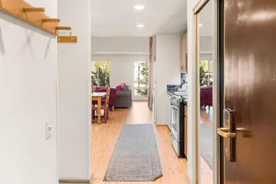 a hallway leading to a kitchen and a dining room at Palisades Tahoe Lodge Rentals Studio Loft #315 in Olympic Valley