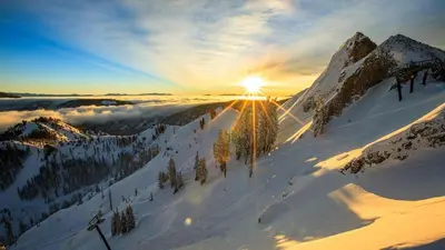 a snow covered mountain with the sun shining on it at Palisades Tahoe Lodge Rentals Studio Loft #310 in Olympic Valley