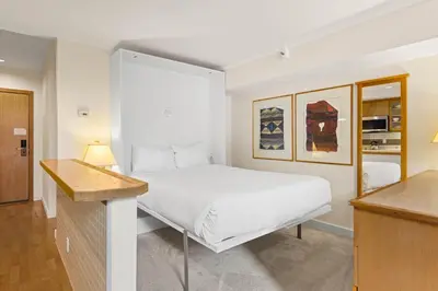 a white bedroom with a bed and a desk at Palisades Tahoe Lodge Rentals Studio Loft #310 in Olympic Valley