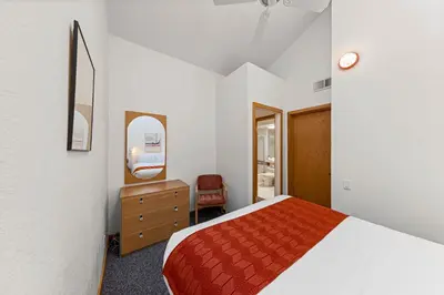 a bedroom with a bed and a dresser and a mirror at Palisades Tahoe Lodge Rentals Studio Loft #317 in Olympic Valley