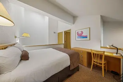 a hotel room with a bed and a desk at Palisades Tahoe Lodge Rentals Studio Loft #305 in Olympic Valley