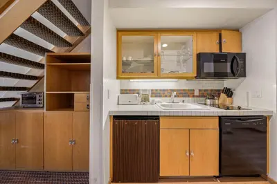 a kitchen with a sink and a microwave at Palisades Tahoe Lodge Rentals Studio Loft #305 in Olympic Valley
