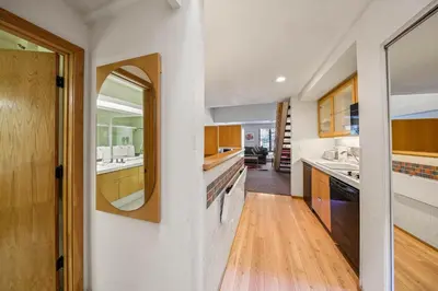 a kitchen with a sink and a mirror at Palisades Tahoe Lodge Rentals Studio Loft #305 in Olympic Valley