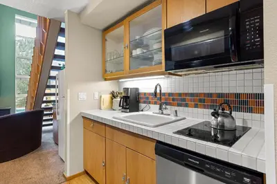 a kitchen with a sink and a microwave at Palisades Tahoe Lodge Rentals Studio Loft #331 in Olympic Valley