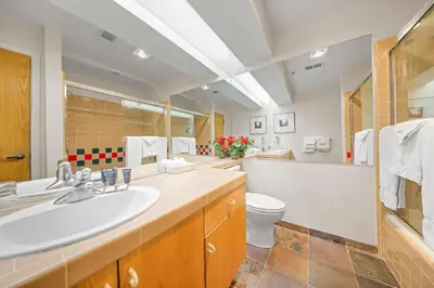 a large bathroom with a sink and a toilet at Studio Loft #348 in Olympic Valley