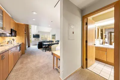 a kitchen and living room with a dining room at Palisades Tahoe Lodge Rentals Studio Loft #349 in Olympic Valley