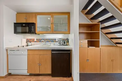 a kitchen with a sink and a microwave at Palisades Tahoe Lodge Rentals Studio Loft #314 in Olympic Valley