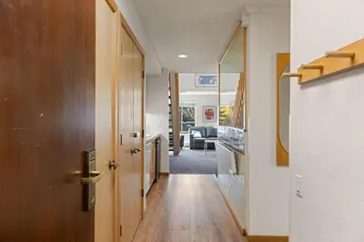 a hallway with a door leading to a living room at Palisades Tahoe Lodge Rentals Studio Loft #314 in Olympic Valley