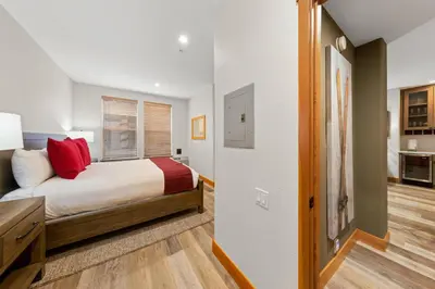 a bedroom with a bed with red pillows at Palisades Tahoe Lodge Rentals Premium Two Bedroom #700 in Olympic Valley