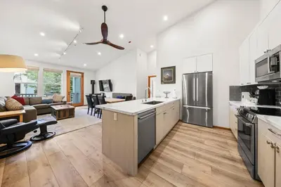 an open kitchen and living room with a couch at Palisades Tahoe Lodge Rentals Premium Two Bedroom #805 in Olympic Valley