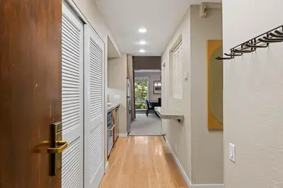 a hallway of a home with a door and wooden floors at Palisades Tahoe Lodge Rentals Premium Studio Loft #313 in Olympic Valley