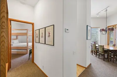 a room with a mirror and a dining room at Palisades Tahoe Lodge Rentals Two Bedroom #422 in Olympic Valley