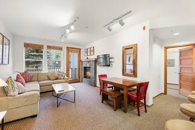 a living room with a couch and a table at Palisades Tahoe Lodge Rentals Two Bedroom #703 in Olympic Valley
