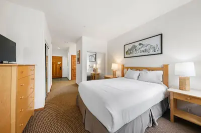 a hotel room with a large bed and a television at Palisades Tahoe Lodge Rentals Two Bedroom #703 in Olympic Valley
