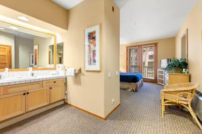a bathroom with two sinks and a mirror at Palisades Tahoe Lodge Rentals Two Bedroom #716 in Olympic Valley