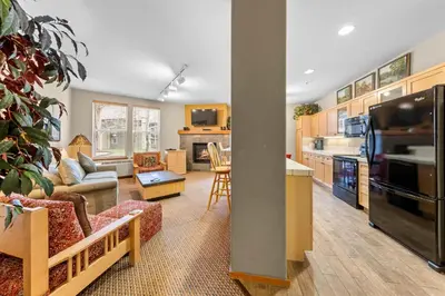 a kitchen and living room with a couch and a table at Palisades Tahoe Lodge Rentals Two Bedroom #716 in Olympic Valley