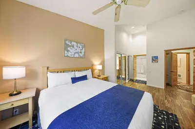 a bedroom with a large bed with a blue blanket at Palisades Tahoe Lodge Rentals Two Bedroom #813 in Olympic Valley