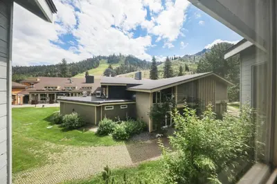 a house with a view of a yard at Palisades Tahoe Lodge Rentals Two Bedroom #813 in Olympic Valley