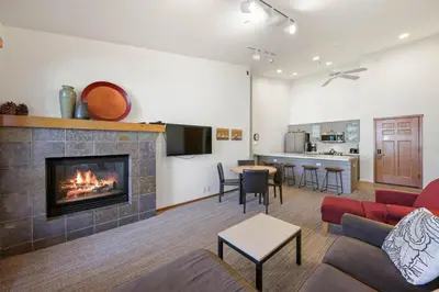 a living room with a fireplace and a kitchen at Two Bedroom #801 in Olympic Valley