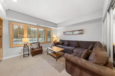 a living room with a couch and a table at Palisades Tahoe Lodge Rentals Premium Studio #227 in Olympic Valley