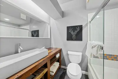 a bathroom with a toilet and a sink and a shower at Palisades Tahoe Lodge Rentals Premium Studio #227 in Olympic Valley
