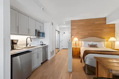 a large bedroom with a bed and a kitchen at Palisades Tahoe Lodge Rentals Premium Studio #105 in Olympic Valley