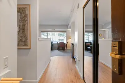 a hallway leading to a living room with white walls at Palisades Tahoe Lodge Rentals Premium Studio #105 in Olympic Valley
