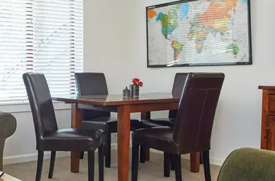 a dining room table with chairs and a world map on the wall at Palisades Tahoe Lodge Rentals Premium Studio #105 in Olympic Valley