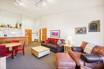 a living room with a couch and a table at Palisades Tahoe Lodge Rentals Two Bedroom #814 in Olympic Valley