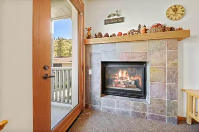 a fireplace in a living room with a fire place at Palisades Tahoe Lodge Rentals Two Bedroom #814 in Olympic Valley