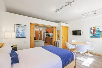 a bedroom with a bed and a table and chairs at Palisades Tahoe Lodge Rentals Premium Studio #149 in Olympic Valley