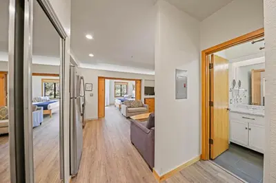 a living room with a couch and a kitchen at Palisades Tahoe Lodge Rentals Premium Studio #149 in Olympic Valley