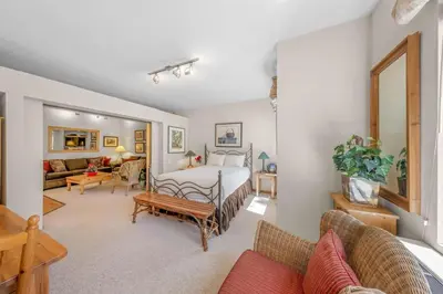 a bedroom with a bed and a living room at Palisades Tahoe Lodge Rentals Studio #143 in Olympic Valley