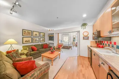 a living room with a couch and a table at Palisades Tahoe Lodge Rentals Studio #143 in Olympic Valley