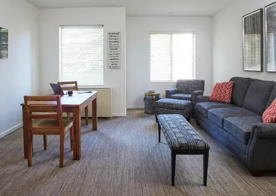 a living room with a couch and a table at Palisades Tahoe Lodge Rentals Premium Studio #252 in Olympic Valley