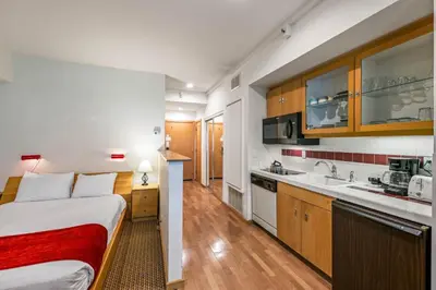 a hotel room with a bed and a kitchen at Palisades Tahoe Lodge Rentals Studio #104 in Olympic Valley