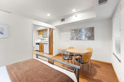 a bedroom with a bed and a table and chairs at Palisades Tahoe Lodge Rentals Studio #109 in Olympic Valley