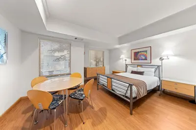 a bedroom with a bed and a table and chairs at Palisades Tahoe Lodge Rentals Studio #109 in Olympic Valley