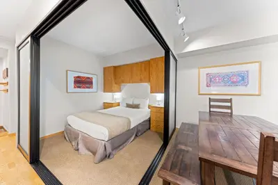 a hotel room with a bed and a table at Palisades Tahoe Lodge Rentals Studio #110 in Olympic Valley