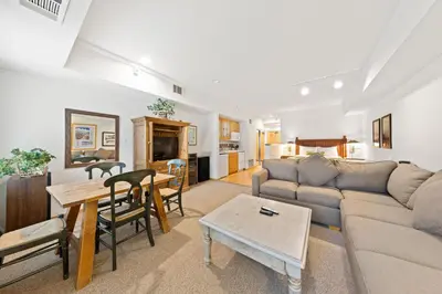 a living room with a couch and a table at Palisades Tahoe Lodge Rentals Studio #111 in Olympic Valley