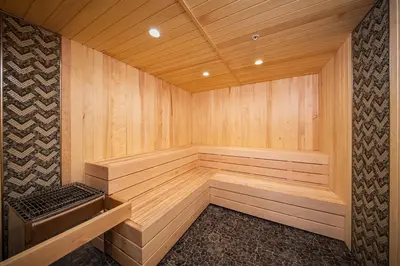 a large wooden sauna with a bench in it at Palisades Tahoe Lodge Rentals Studio #115 in Olympic Valley